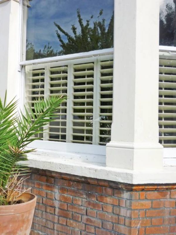 shutters for bay windows outside of building Fitted by the shutter company Newport