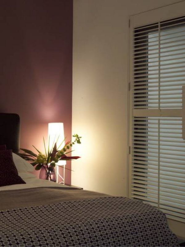 inside white door shutter in modern bedroom - double bed